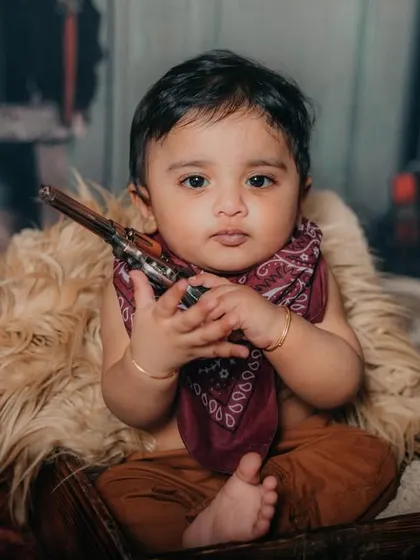 Another shot of our little cowboy, looking tough with his toy gun. These themed shoots are full of character.