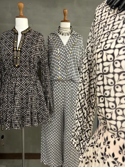 A collection of black and white printed ensembles. From a peplum top to a jumpsuit, these pieces showcase how classic prints can be used in modern, chic silhouettes.