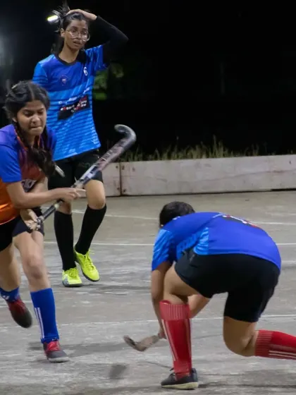An intense moment of play as our player in orange and blue dribbles past a defender during the exhibition match in Trombay.