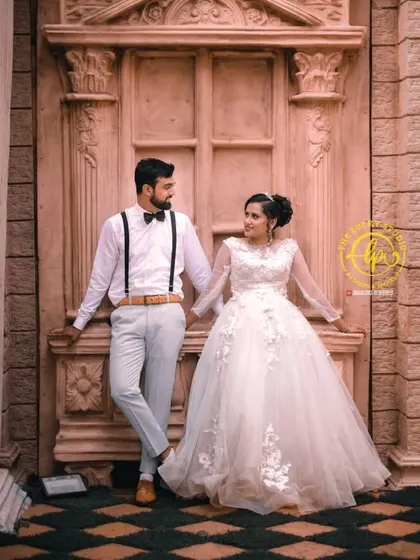 The couple posing against an architectural backdrop. Their classic black and white attire, which I styled, offers a timeless look that works well in almost any setting.