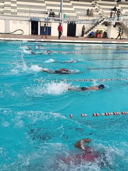 The water churns as my swimmers race during a time trial. These sessions are crucial for tracking progress and getting comfortable with swimming at maximum effort.