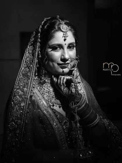 A classic black and white bridal portrait. The soft lighting and the bride's gentle smile create a timeless and elegant image that will be cherished forever.
