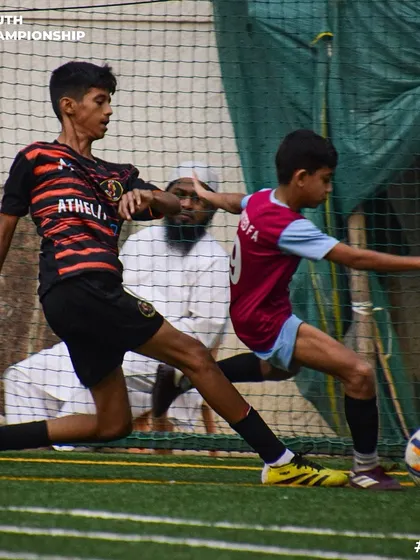 A physical duel for the ball, showcasing the strength and commitment of our players.