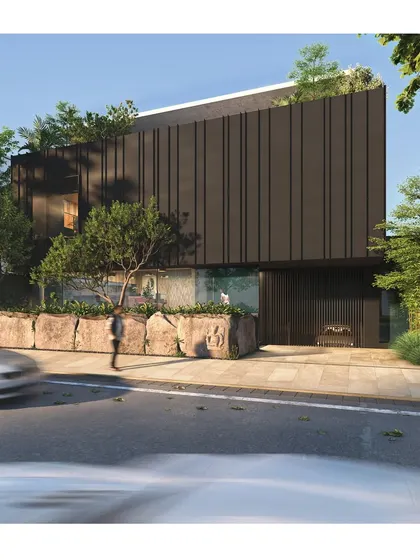 A render of an upcoming office block, envisioned as a dark, monolithic volume floating above a transparent glass base. The design plays with concepts of weight and lightness, grounding the building with a natural stone wall at the street level.