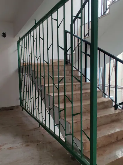 The tree-inspired railing adds an artistic and organic touch to the common areas of the apartment building.