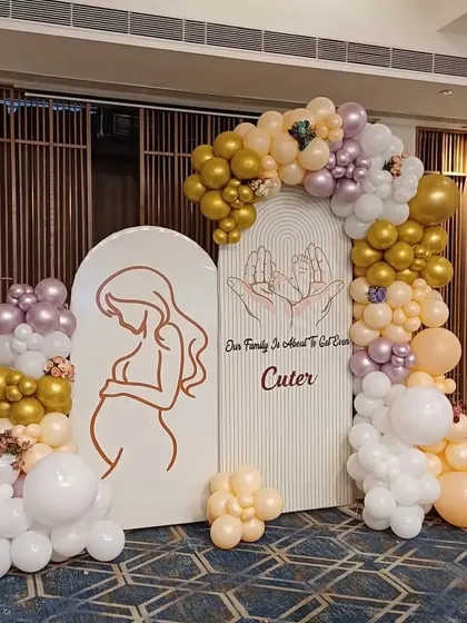 A different angle of the elegant baby shower backdrop, showing how the balloon garlands are arranged to create a sense of depth and texture.