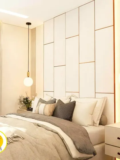 A close-up of the panelled headboard with its subtle gold trim, adding a touch of luxury.