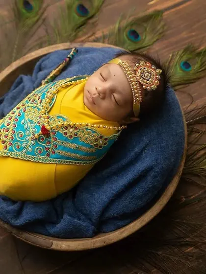 A top-down view of the Little Krishna setup, showing the baby peacefully wrapped in a bowl.