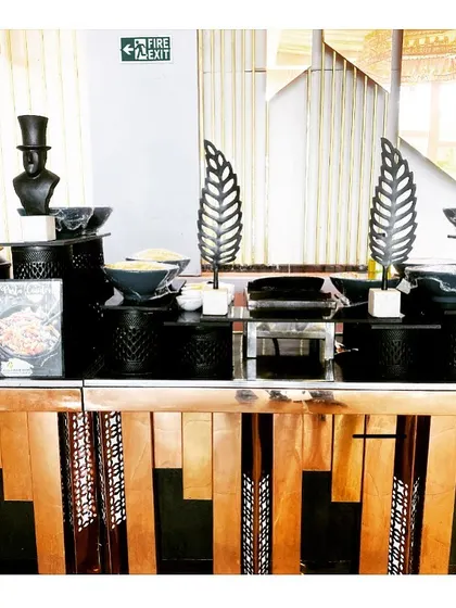 A modern and chic black-and-copper themed buffet setup, perfect for a contemporary wedding or corporate event.