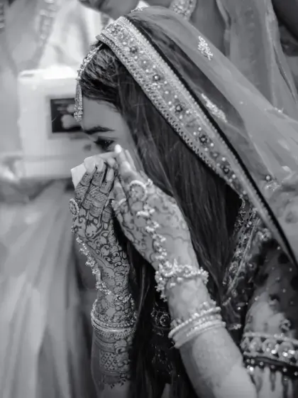 An emotional black and white photo of the bride during a heartfelt moment of the ceremony, capturing the raw emotion of the day.