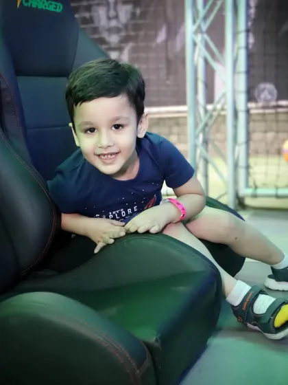 A young boy smiles for the camera while enjoying the party.