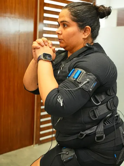 A close up of Sumukhi Suresh's focus and determination during her EMS session. It's all about that mind muscle connection.