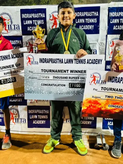 The top three finishers at the ILTA prize money tournament, holding their trophies and prize money checks. We host competitive tournaments to give our players valuable match experience.