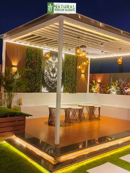 The completed pergola and seating area in our Shahdara project. The space features a vertical garden, custom art, and layered lighting for a modern and eclectic vibe.