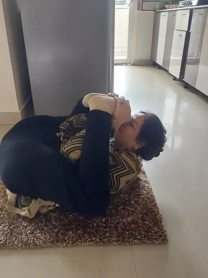 Another angle of the student in a reclined hip-opening pose. Home visits allow us to provide focused attention to help you achieve your wellness goals safely.