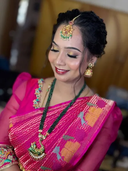 A naming ceremony look for one of my favorite clients. This hairstyle is a twisted updo, and the makeup was done to match her next saree change, showing versatility.