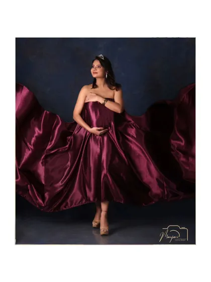 A solo portrait showcasing the magnificent flowing fabric of the satin gown. The mama-to-be looks like a true diva.