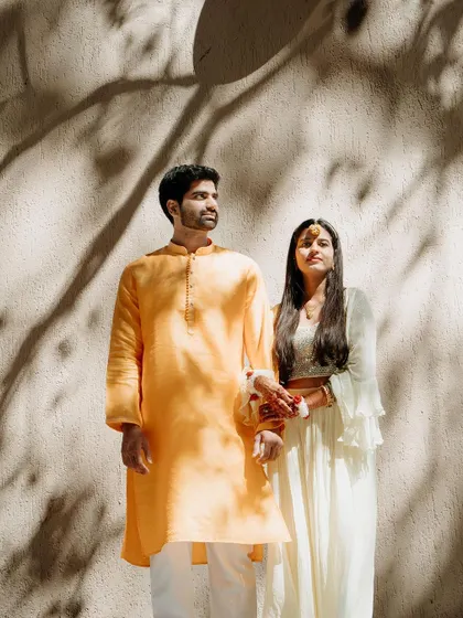 A serene portrait of the couple holding hands, the natural light and shadows adding a beautiful, artistic quality.