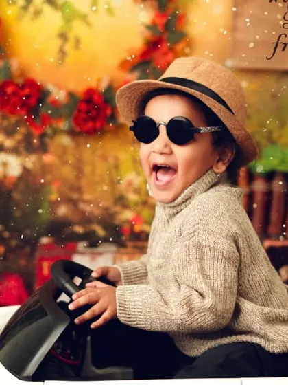 Cruising into his next adventure. The toy car and cool sunglasses give this shot a fun, carefree vibe that is full of personality.