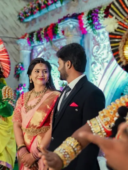 The couple looks on as Yakshagana artists perform, a unique cultural element that made their reception truly special.
