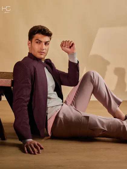 A relaxed pose in the maroon shacket and pink trousers, showing how these pieces move with you while maintaining a sharp, contemporary silhouette.
