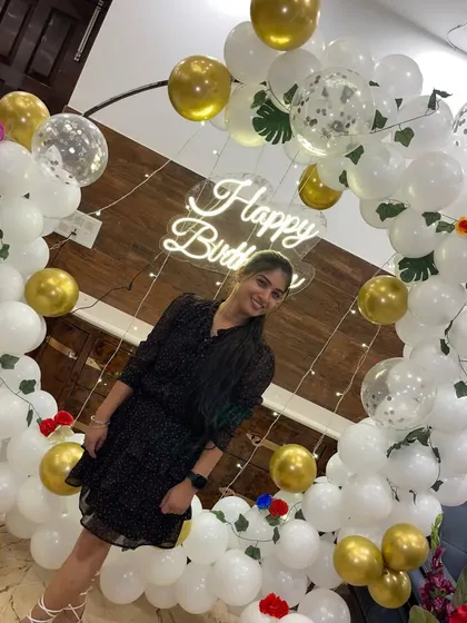 A portrait shot highlighting the beautiful details of the white and gold balloon decor.