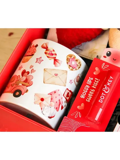 A close-up of the custom-printed mug and Dot & Key lip balm from our '7 Days of Valentine' hamper.