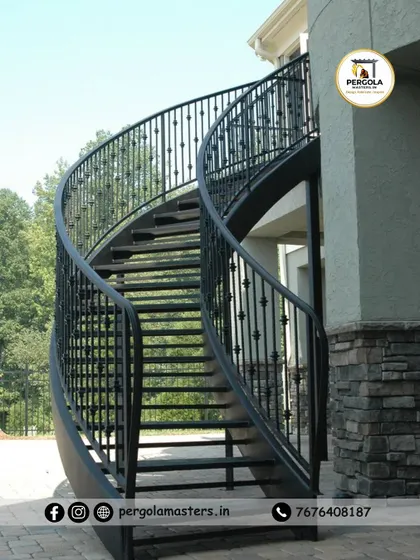 An elegant, free-standing curved metal staircase designed for an exterior space. The smooth curves and detailed balusters demonstrate our precision fabrication skills, creating a timeless architectural feature that adds grace and value to the property.