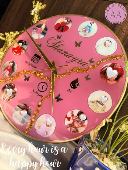 Celebrate every precious moment with a custom baby clock. This bright pink resin clock features twelve photos from baby Shanayra's first year, along with her birth details, making it a perfect centerpiece for a nursery.