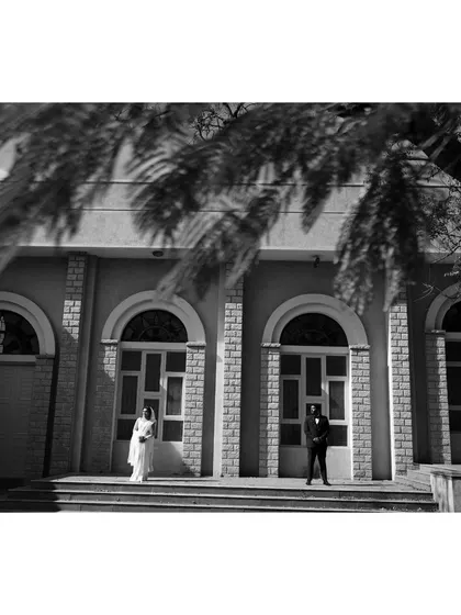 A black and white architectural shot of a Christian couple. This timeless style emphasizes composition and emotion.