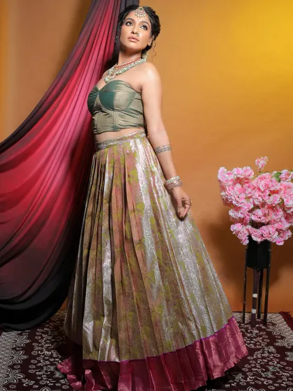 Where tradition meets modern elegance. This look features a contemporary lehenga with a corset-style top, paired with makeup that is both traditional and chic.