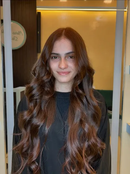 A smiling client happy with her new copper brown global color. It's a timeless and beautiful choice.