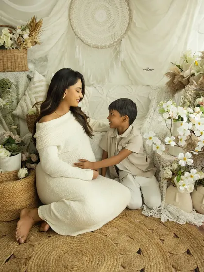 A conversation between a mother and her firstborn. This gentle, seated portrait captures the special bond they share as they talk about the new baby on the way.