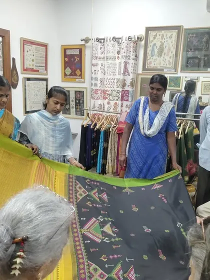 Students from SKV School of Design examining a hand-embroidered Ilkal saree. These visits provide valuable, real-world lessons in craft and design.