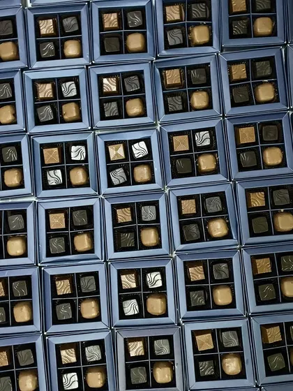 Gifting never tasted so divine. This image shows a large order of our four-piece assorted chocolate boxes, perfect for corporate events or wedding favors.