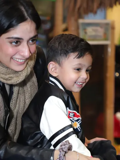 I create a warm and engaging environment where parents can share special moments with their children during the celebration.