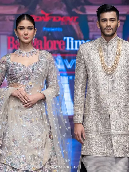 A closer view of the groom's gold sherwani from the Aurous collection. The exquisite floral multicolor embellishments are clearly visible, showcasing the craftsmanship.