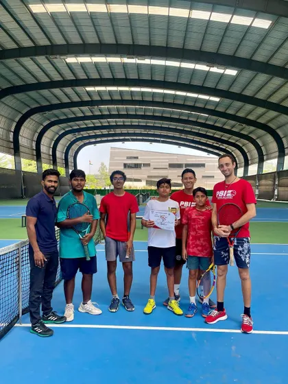 The team celebrates Yashas's U-14 championship. The support of coaches and peers is a vital part of our academy's culture.