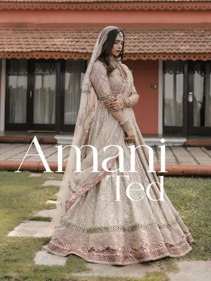 A full-length portrait of the bride in her elegant pastel lehenga in the gardens of the Taj Holiday Village, Goa.