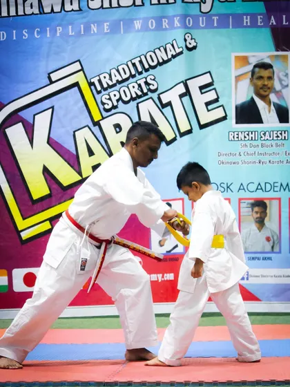 A significant moment in any student's journey is the awarding of a new belt. Here, I am personally fitting a yellow belt, marking a student's progress and dedication. This is a key part of the structured advancement in my program.