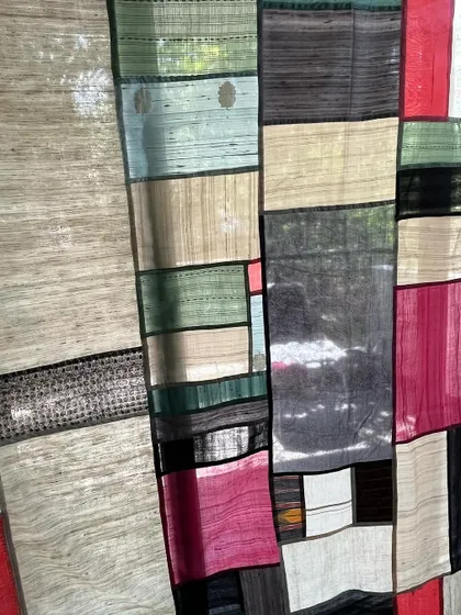 A close-up of the Pojagi room divider, showing how the light shines through the different fabrics.