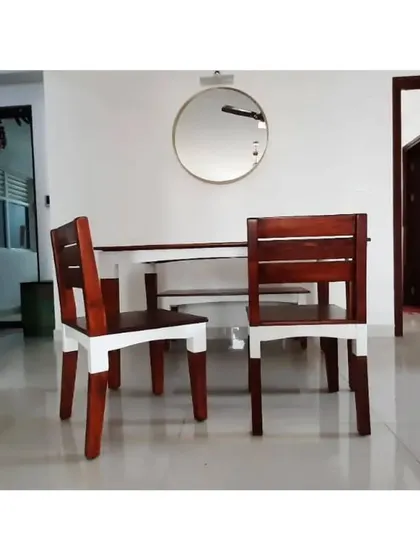 A close-up of the two-tone dining chairs, showcasing the contrast between the polished wood seat and backrest and the painted white legs. This design adds visual interest while maintaining a clean, modern aesthetic.