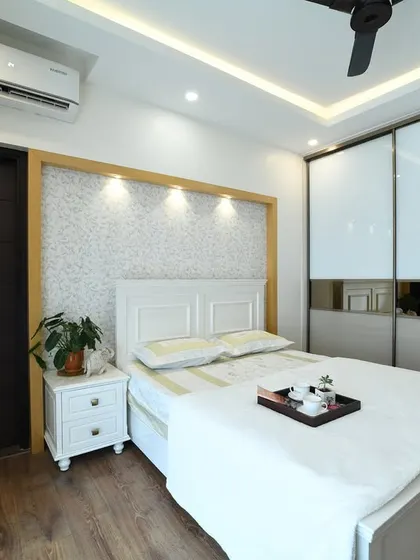 A view of the bedroom highlighting the white aristo wardrobe with tinted mirror panels, which adds to the room's bright and spacious feel.