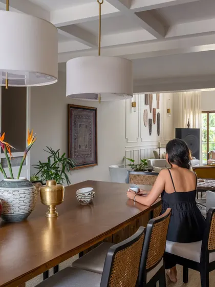 A view from the dining area looking into the expansive living spaces. The layered design, with its mix of textures and styles, unfolds like a story as you move through the home, creating an inviting and luxe atmosphere.