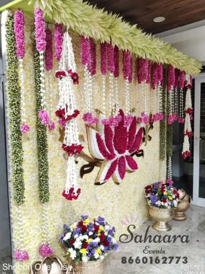 An intricate and beautiful floral wall for a traditional seemantham or baby shower. This design uses jasmine, tuberose, and lotus flowers to create a stunning and fragrant backdrop.