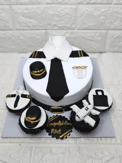 A sweet way to celebrate reaching new heights! This pilot themed cake and matching cupcakes were for a client's graduation, with a Ferrero Rocher and Nutella flavor inside.