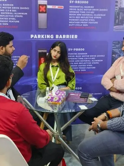 A team meeting with potential clients at Traffic Infratech 2024, discussing the specifications of our residential and parking barrier systems.
