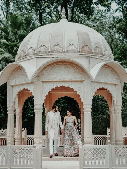 A beautiful couple portrait from a Mehendi ceremony, set against the backdrop of a stunning white marble gazebo.