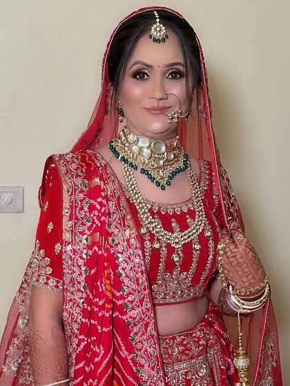 A portrait of elegance. This minimal makeup look enhances her natural beauty, proving that a red lehenga can be paired with a subtle face for a timeless effect.