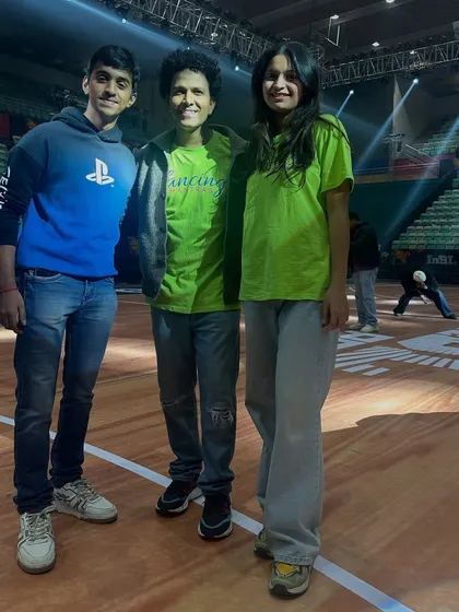 A quick photo with some of my team members during a break in rehearsals at the stadium. The positive energy is constant, even during long practice hours.